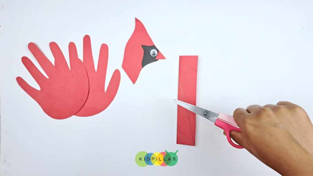 Paste googly eye and cut out the tail for cute cardinal craft with paper plate