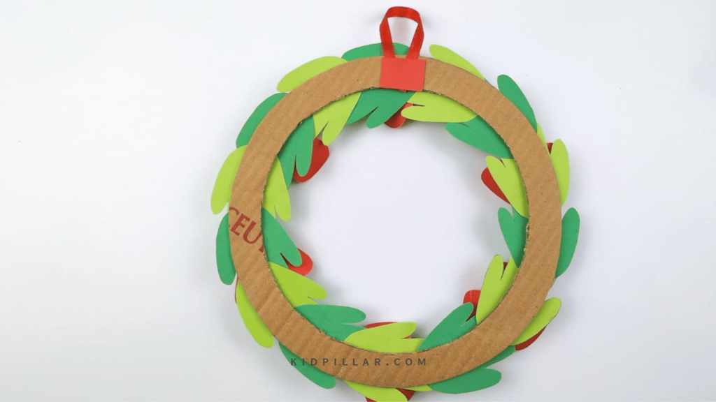 Paste a small ribbon loop at the back of your DIY Poppy Wreath craft for kids