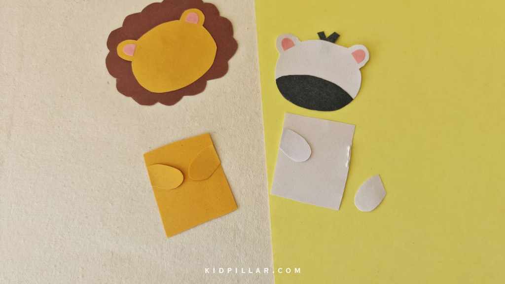 Paste the paws on the body of DIY safari animals craft for kids