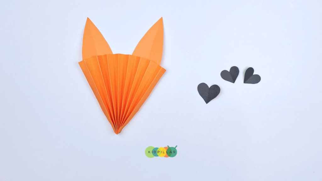 Cut heart shapes for eyes of easy heart fox craft for school