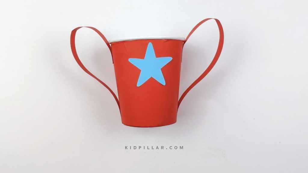 Paste star on the cup of mother's day trophy for preschooler