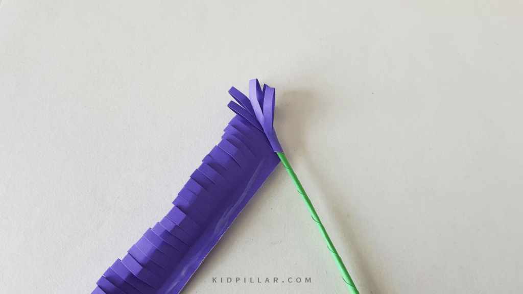 Glue the flower strip on the stem of easy paper hyacinth craft for kids