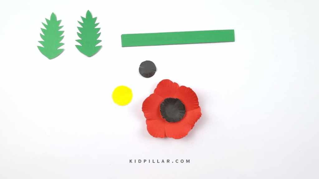 Glue the black circles in the center of paper poppy flower craft