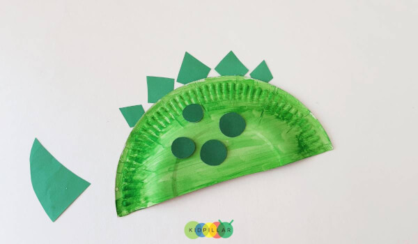 Paste dinosaur plates on fun dinosaur craft