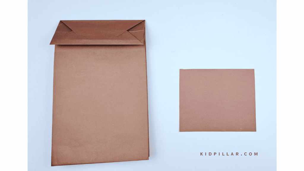 Cut a small rectangle from brown paper to make wings for paper bag owl craft