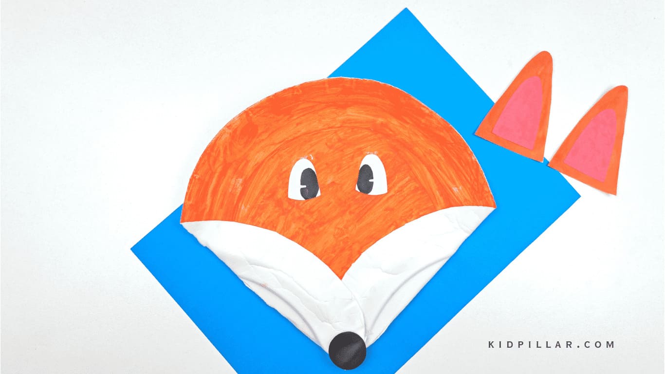 Glue eyes and nose to make paper plate fox craft easy