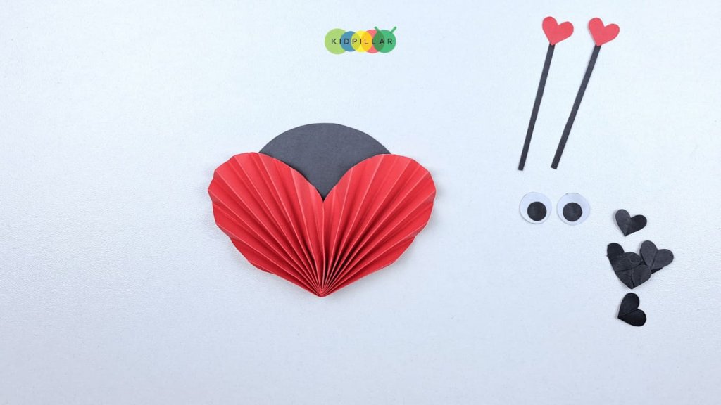 Glue the head on body of valentine Heart ladybird craft easy