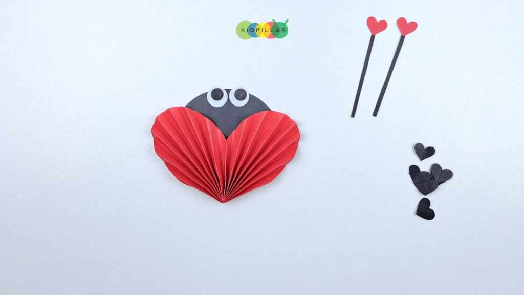 Glue eyes on valentine Heart ladybug craft