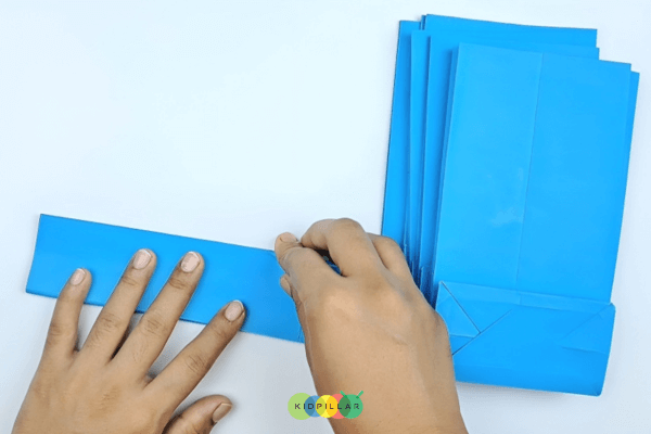 Fold along the length to make Blue paper bag snowflake winter craft