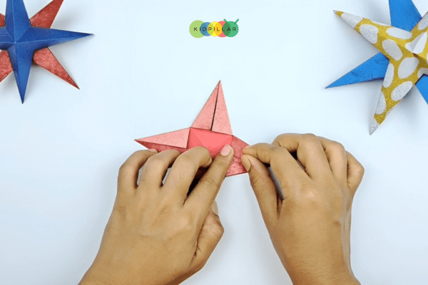 Fold the triangles for star Christmas ornamental craft